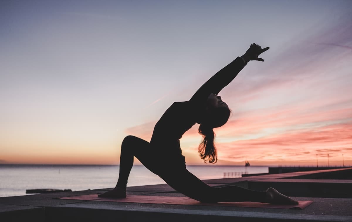A person stretching on a yoga mat