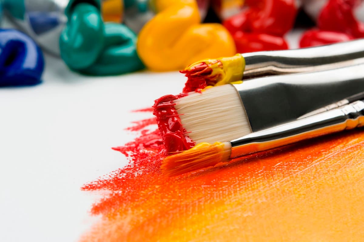 Watercolor paints and brushes on a table